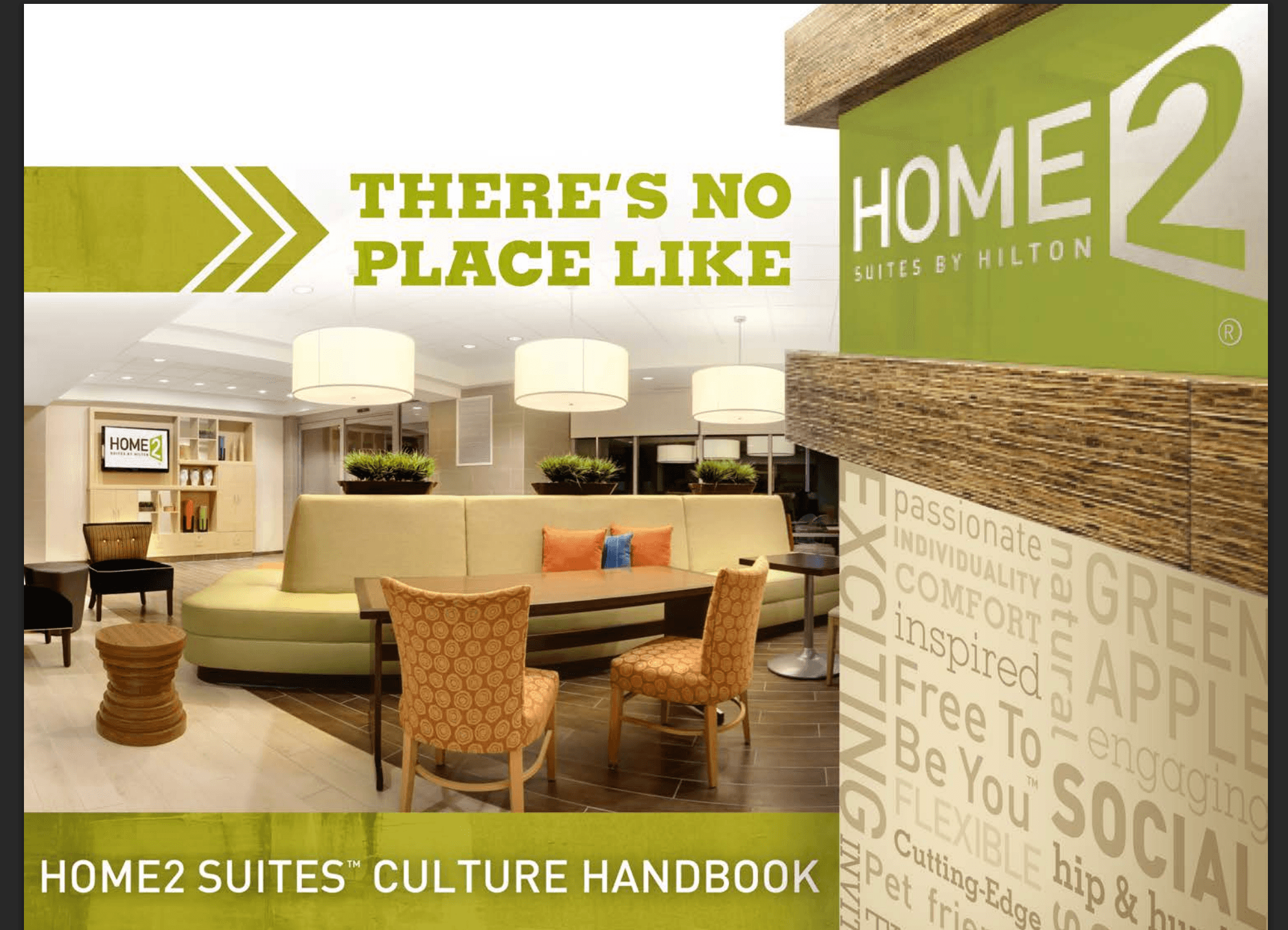 Hotel lobby with seating area, green and beige decor, and a sign reading 'HOME2 Suites Culture Handbook'.