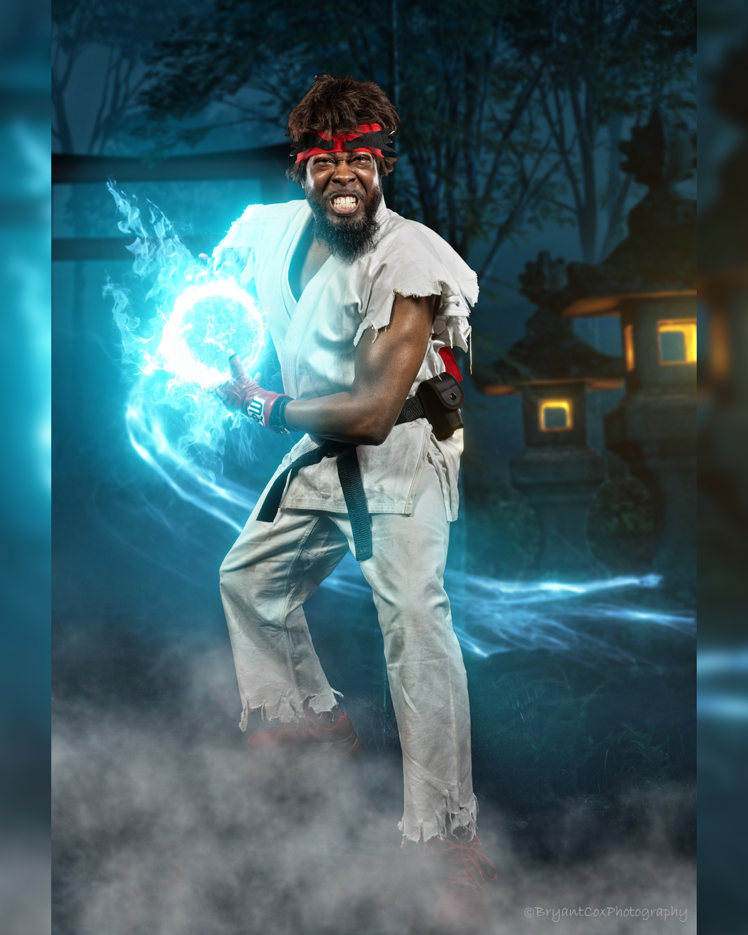 Man with a headband and torn clothes conjures blue energy with a fierce expression, standing in a misty outdoor setting at night.