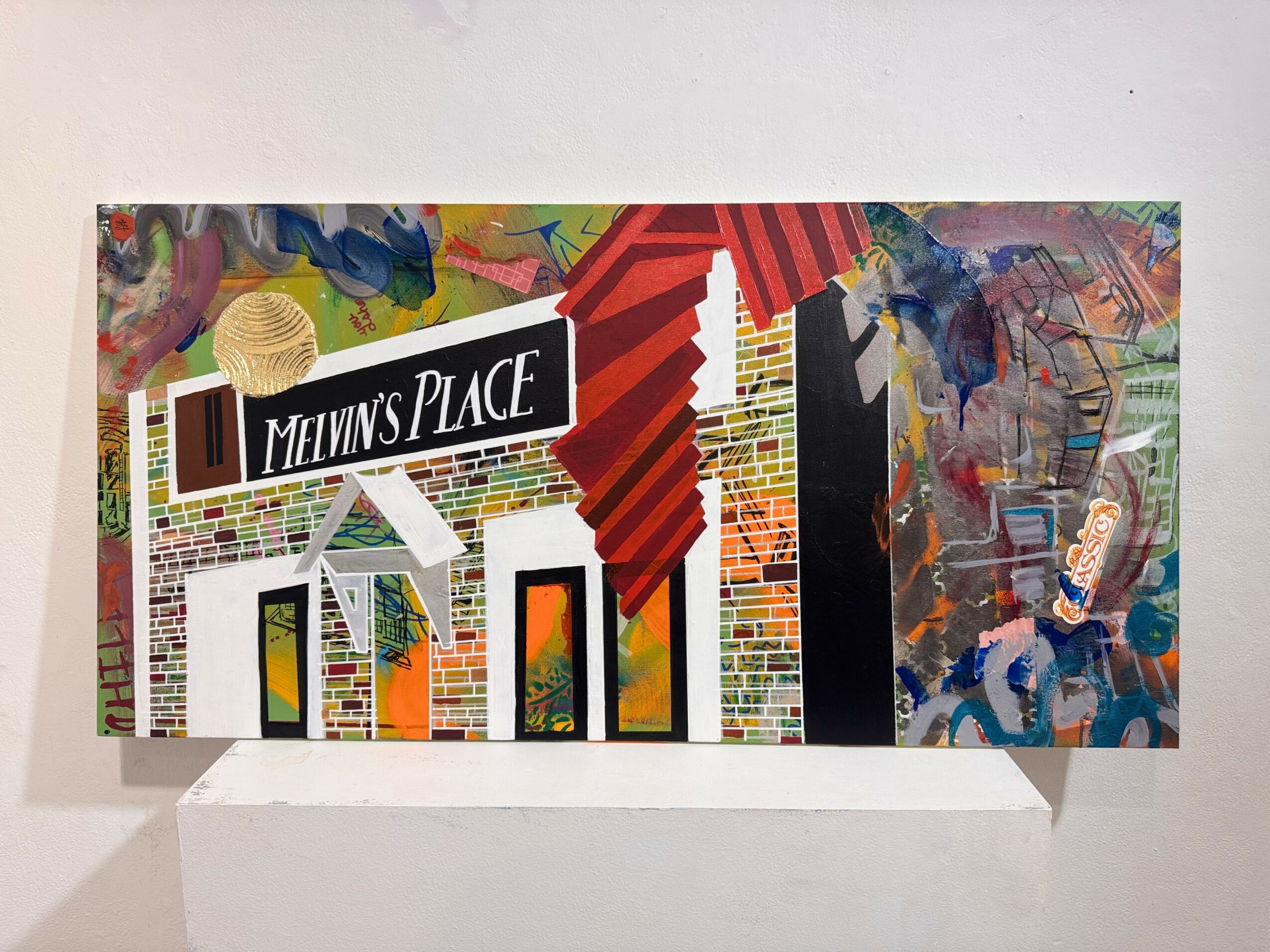 Colorful abstract mural with text 'Melvin's Place' and geometric shapes, on a white wall.
