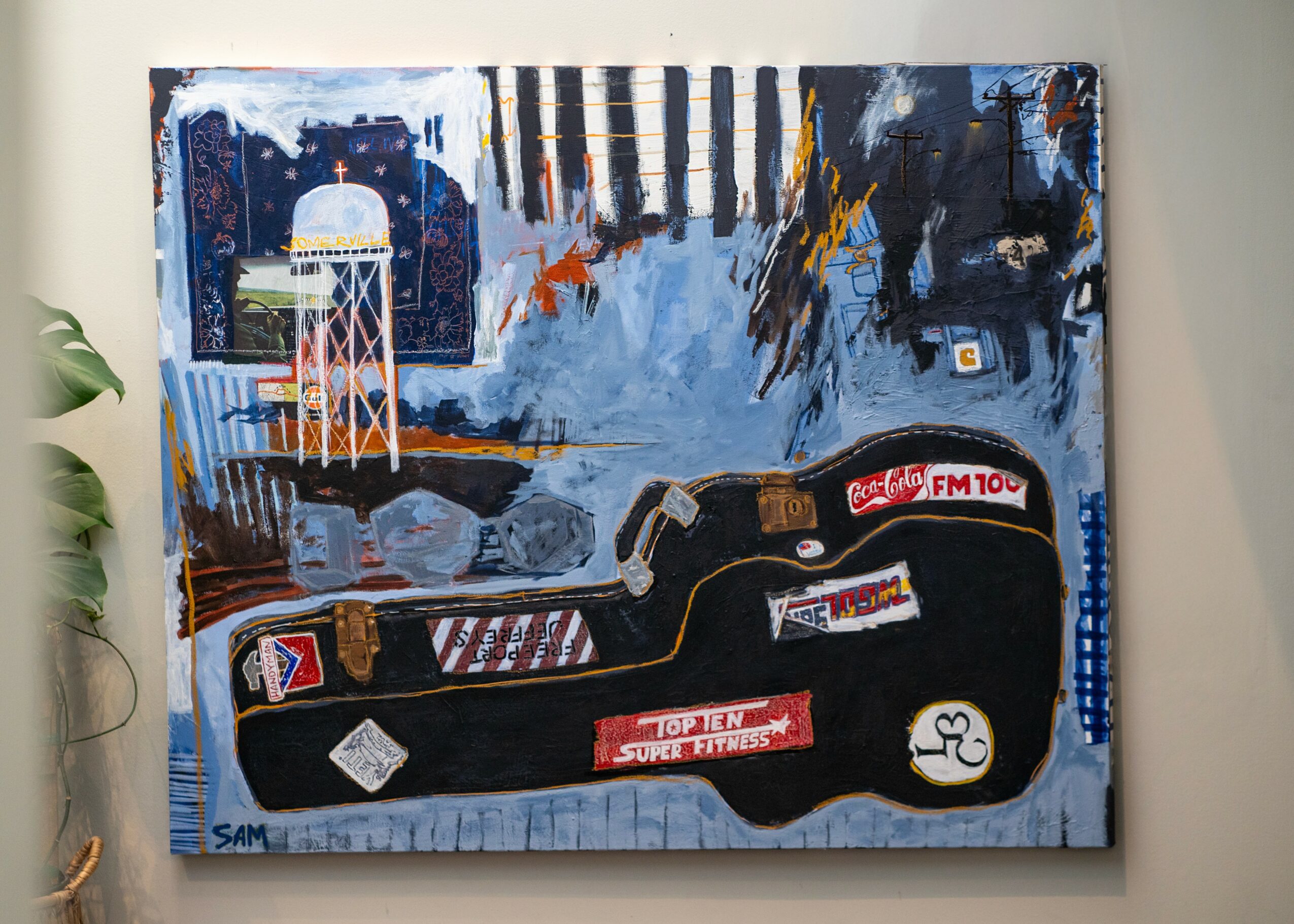 Abstract painting with a water tower, guitar, and various shapes in blue, black, white, and orange colors.